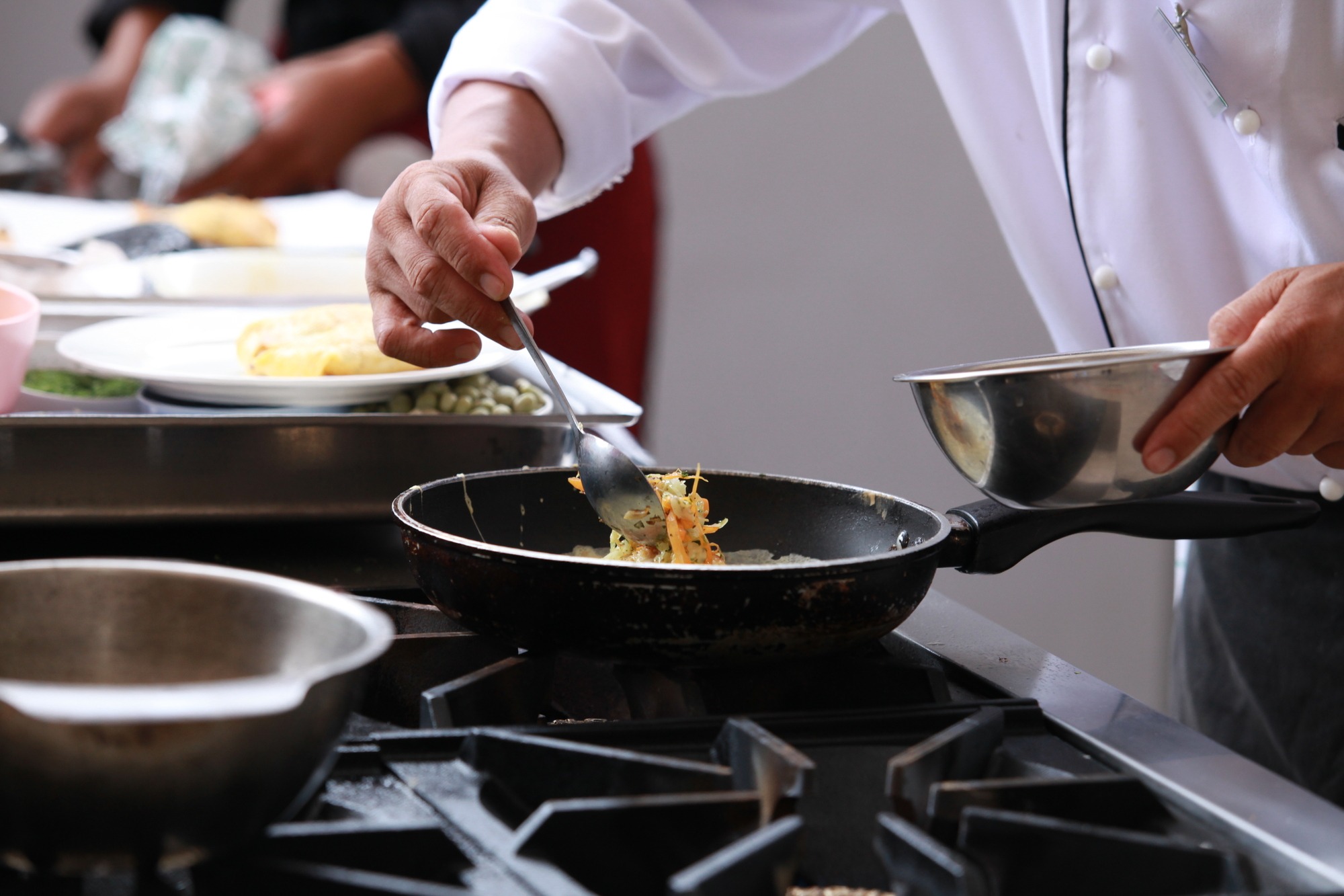 Chef in Restaurant Kitchen Cooking.